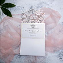 white laser cut wedding invitation with bow